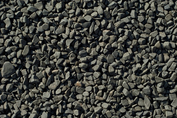 Drainage systems from small pebbles. Garden drainage for plants and trees. Black stones for roads and flower beds.