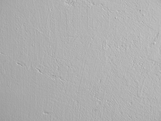 light grey painted plaster wall background with brush marks texture