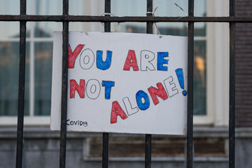 Coronavirus motivation sign of "you are not alone" made by children to support the community in bad times of covid 19