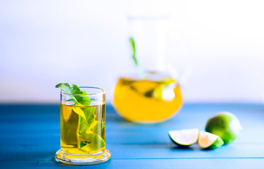Closeup green tea view with lime and carafe studio shot