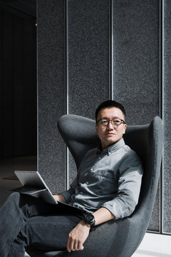 Businessman using laptop in office lobby