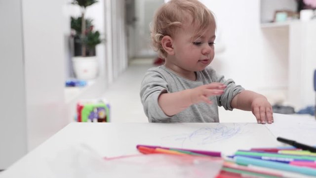 Young girl drawing at home with felt tips