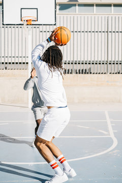 Basketball player practicing on street court