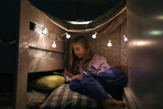 Kid playing in her tiny home, inside the room.