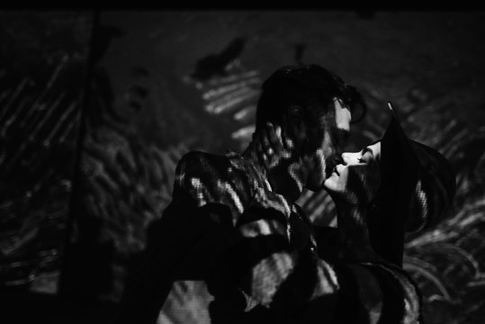 anonymous couple kissing in dark room