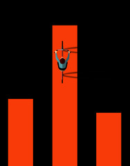 A cyclist on a bicycle is seen from above as he pedals on an orange bike trail bordered by black.