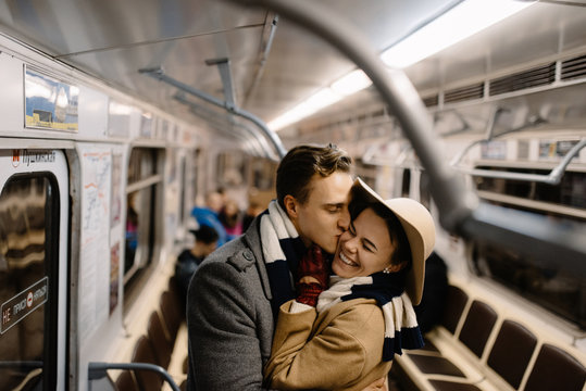 couple kissing in subway