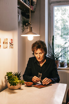 Old Caucasian Woman Preparing CDB Cannabis at Home