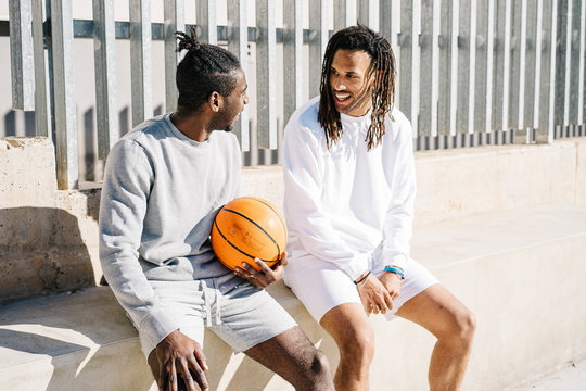 Basketball players resting after training on playground