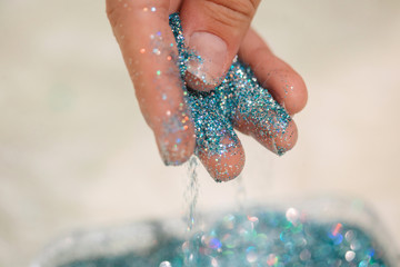 Crop model spilling blue glitter