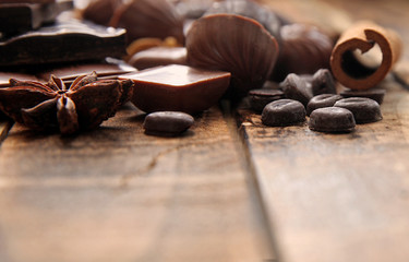 Dark chocolate pieces on a wooden table, copy space