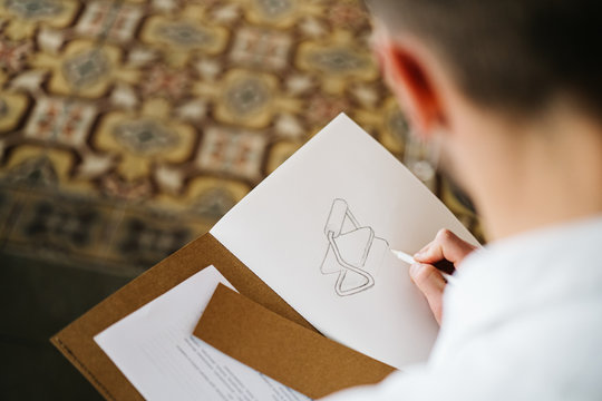 Male artist sketching on sofa