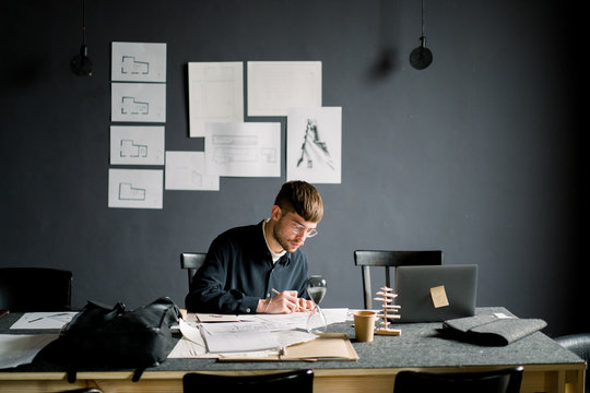 Thoughtful designer drawing sketches