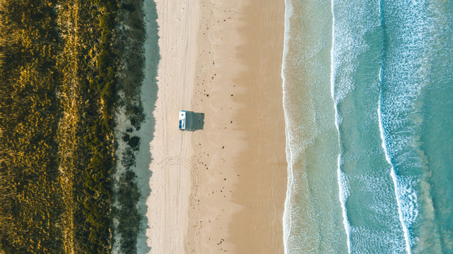 camping truck driving on beach