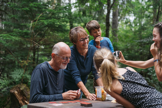 Fun loving grandparents playing card games with grandkids on cam