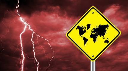 Concept of the world crisis. Warning road sign with a map of the world. Warning symbol on a background of a stormy sky. Problems all over the world.