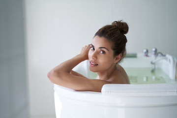 Obraz premium Happy pretty lady enjoying time in hydrobath