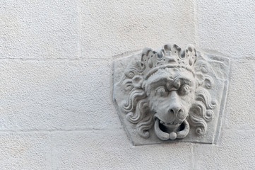 Lion head in crown on the wall of old building in Lviv, Ukraine 