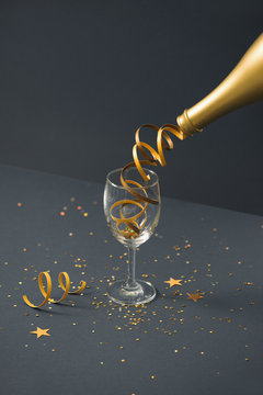 Champagne bottle with glass on lights background. New year concepts