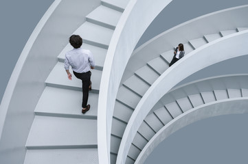 Businessman and businesswoman walking on office stairs