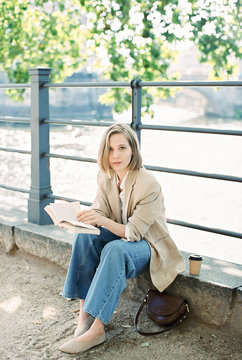 young woman by the river in the city