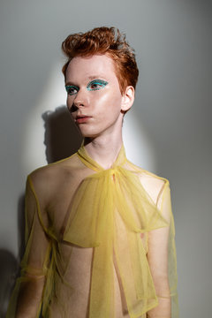 Androgynous man in transparent blouse