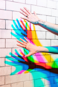 Female hands under colored lights