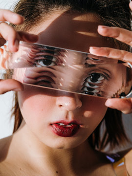 Asian model looking at camera through glass