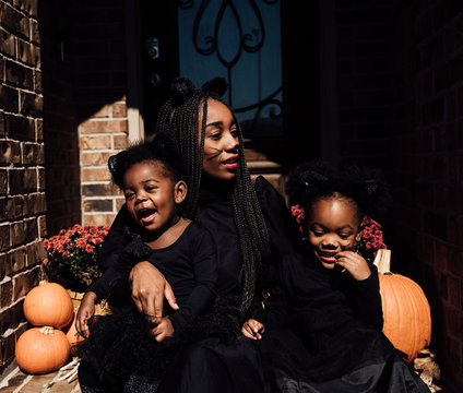 Mom and daughters dressed in black for Halloween