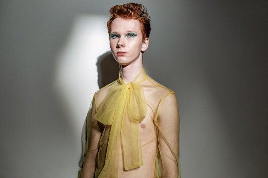 Androgynous man in transparent blouse