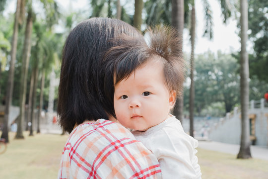 Asian mother with a baby outdoor