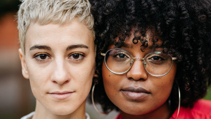 Calm young multiracial friends looking at camera