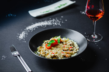 Risotto mushrooms chicken on black plate
