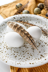 Fototapeta na wymiar White background with white eggs and feathers. White background. Top view
