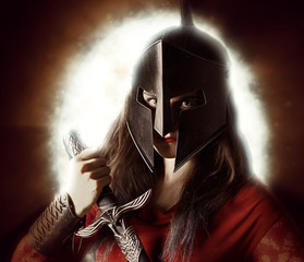 woman with sword gauntlets and roman helmet