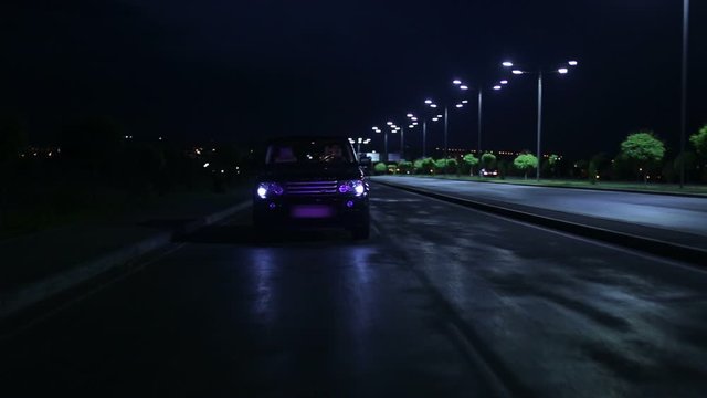 Police car in the side mirror chasing a car on highway. Police chase, the car is running away from the chase