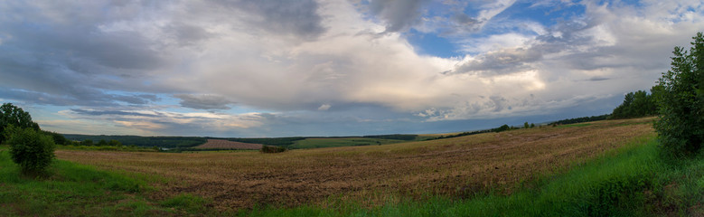 Fototapeta na wymiar panorama of a landscape field with a sunset sky