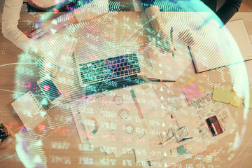 Double exposure of woman hands working on computer and financial theme hologram drawing. Top View. Business concept.