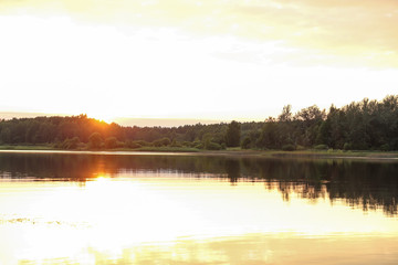 Obraz na płótnie Canvas sunset on the river in summer
