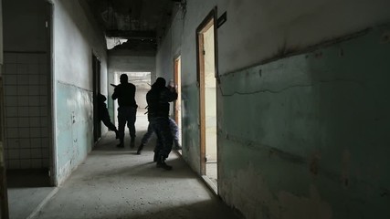 Special police force enters dilapidated building.