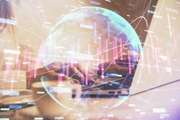 Double exposure of woman hands working on computer and forex graph hologram drawing. Financial analysis concept.