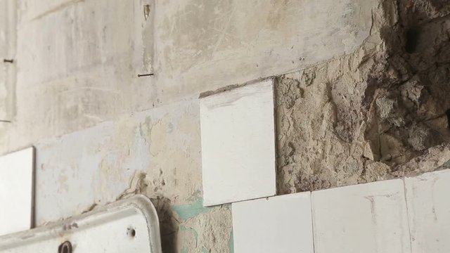 A broken wall crumbling due to an earthquake.
