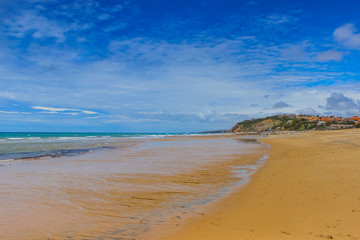 Beautiful landscape with ocean, sea, mountains, blue sky and white clouds