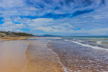 Turquoise sea with tropical beach. Coastline of the ocean, rocks and sand. Sea line from France on the beach. Leisure activities in heavenly resorts, travel concept, lifestyle.