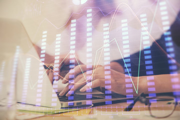 Multi exposure of woman hands typing on computer and financial graph hologram drawing. Stock market analysis concept.