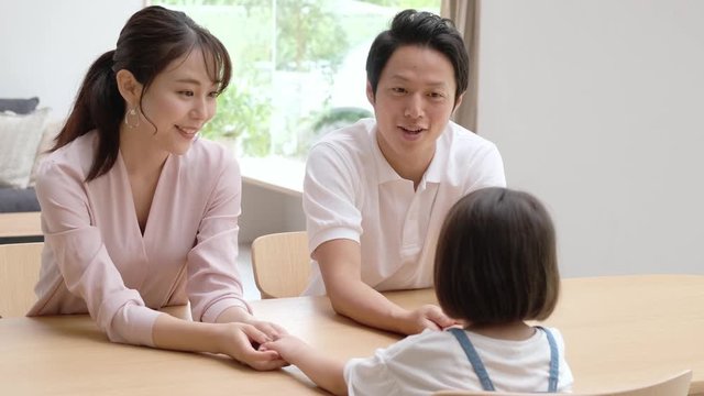 子どもの手を握る両親