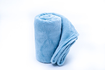 Rolled up blue coral fleece throw isolated on white background