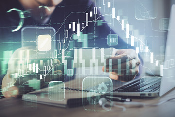 Double exposure of man's hands holding and using a phone and financial graph drawing. Analysis concept.
