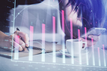 Double exposure of forex graph sketch hologram and woman holding and using a mobile device. Stock market concept.