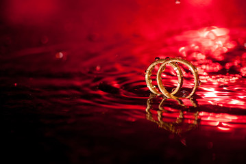 wedding rings on red background